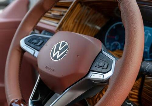 Close-up of a leather-wrapped steering wheel inside a modern car