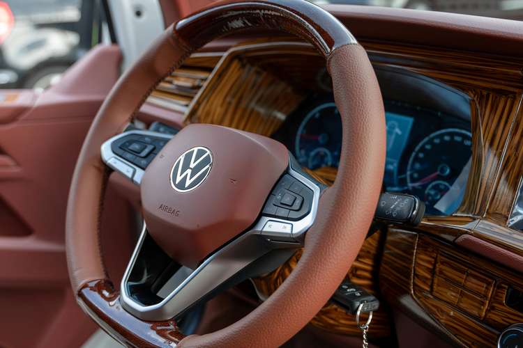 Close-up of a leather-wrapped steering wheel inside a modern car