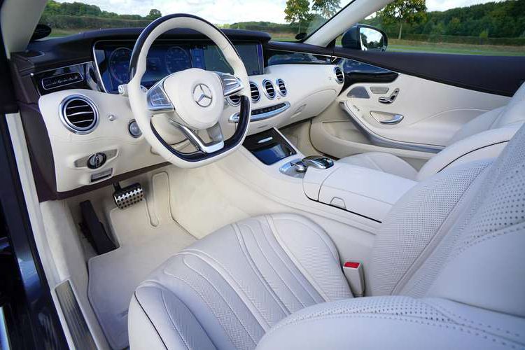Car leather repair San Diego – white leather dashboard and steering wheel in luxury car