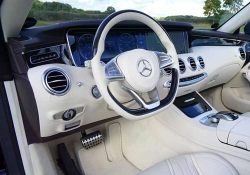 Car leather repair San Diego – white leather dashboard and steering wheel in luxury car