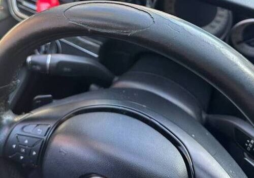 Worn black leather steering wheel interior showing cracks and peeling — Steering Wheel Repair in San Diego