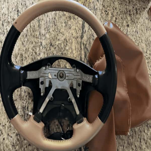 Car steering wheel before color matching – different shade than reupholstered interior