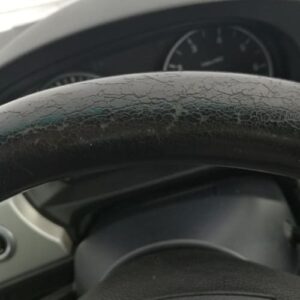 Cracked and worn leather steering wheel before restoration