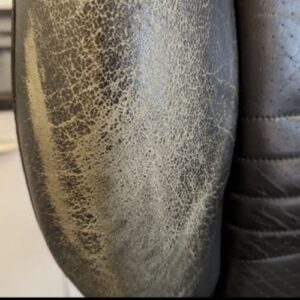 Severely faded brown leather car seat with worn color and surface cracking