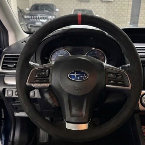 Black Alcantara steering wheel cover installed on Subaru steering wheel