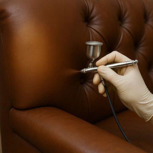 Leather sofa repair in Oceanside — professional airbrush recoloring process restoring smooth brown leather surface with even color finish.