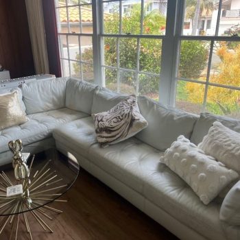 White leather sectional before leather couch restoration, showing orange stains and color wear
